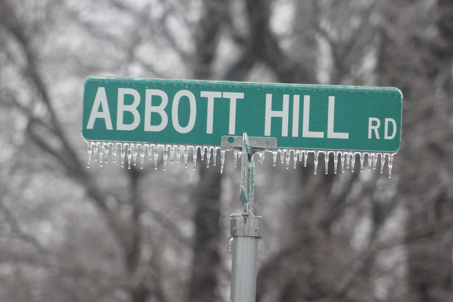 Abbott Hill Road sign with ice